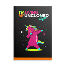 Load image into Gallery viewer, &quot;I&#39;m Living My UnCloned® Life with Dabbing Unicorn&quot;  8.5in x 11in Hardcover Notebook with Puffy Covers