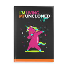 Load image into Gallery viewer, &quot;I&#39;m Living My UnCloned® Life with Dabbing Unicorn&quot;  8.5in x 11in Hardcover Notebook with Puffy Covers